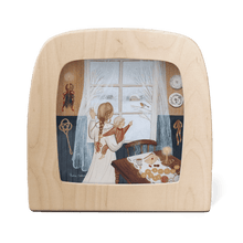 Wooden frame with a scene of two children by a window looking at a robin on a branch.