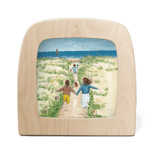 Silhouette of a beach scene with children running to the ocean