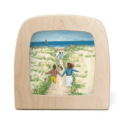 Silhouette of a beach scene with children running to the ocean