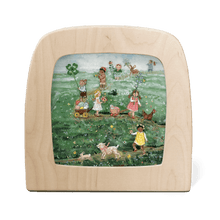 Silhouette of children and animals parading through a grassy meadow