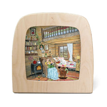 Toverlux lamp featuring a colorful illustration of a cozy log cabin living room on the front, set against a plain white background.
