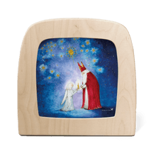Silhouette of St. Nicholas gifting a candle to a young angel