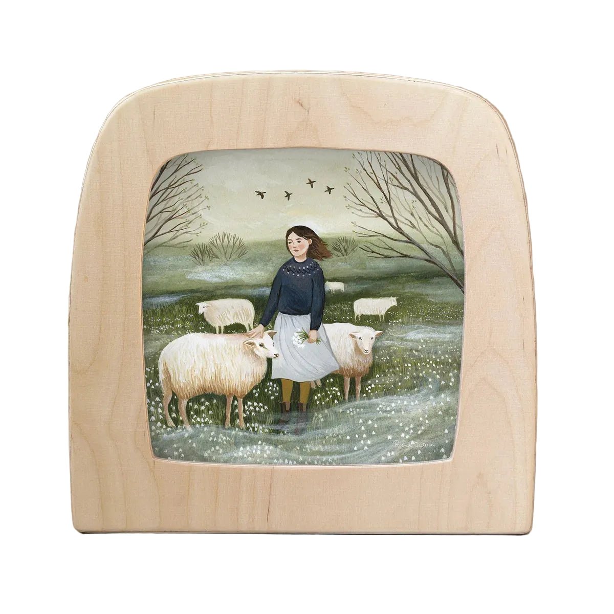 Silhouette of a girl standing in a field with her sheep