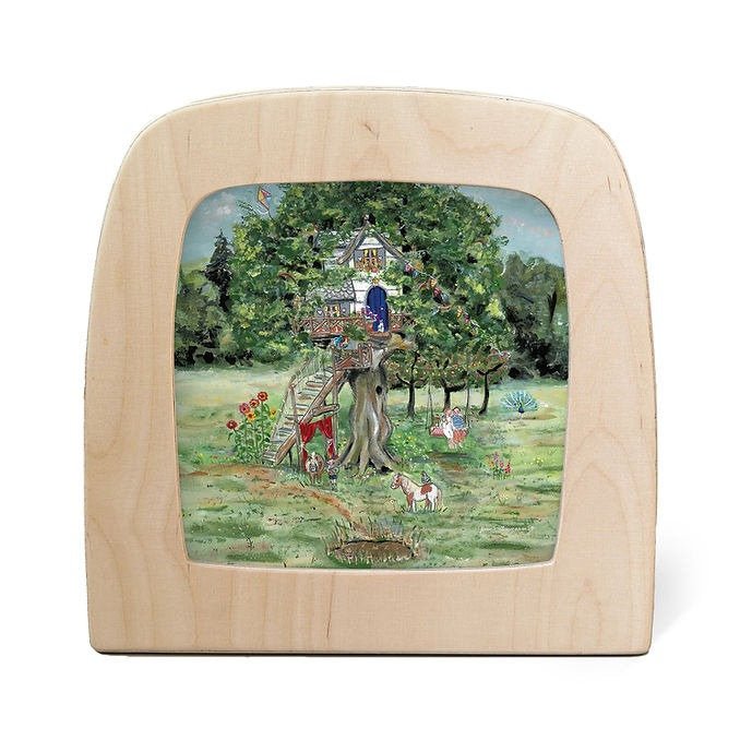 Silhouette of a large treehouse with people in the front yard