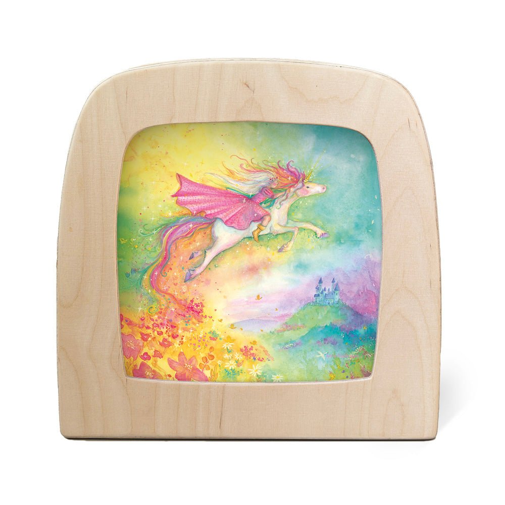 Silhouette of a girl riding a unicorn through the air with a castle in the distance