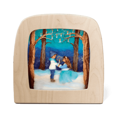 Silhouette of two children holding a candle in a snowy forest