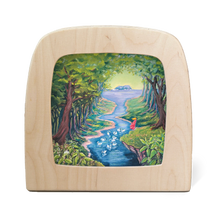 Wooden frame with silhouette of swans in a river surrounded by a forest