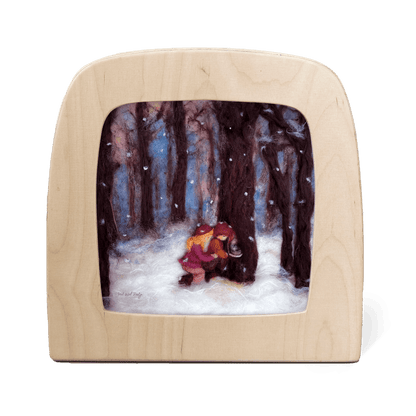 Silhouette of two children in a snowy forest scene