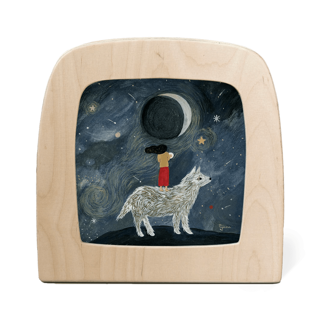 Silhouette of a girl standing on the back of a large white wolf with the moon in the background