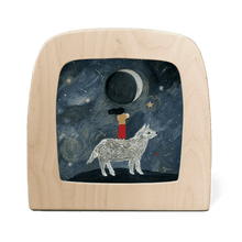 Silhouette of a girl standing on the back of a large white wolf with the moon in the background