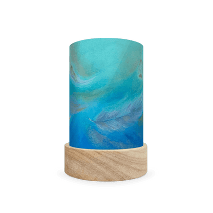 Decorative cylindrical lamp featuring a scene of feathers on a white background