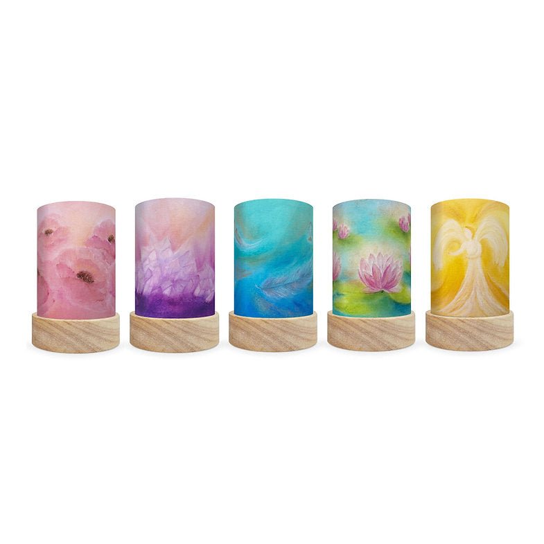 Five decorative cylindrical lamps featuring calming scenes on a white background