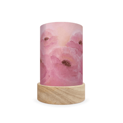 Decorative cylindrical lamp featuring a scene of pink poppies on a white background