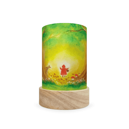 Decorative lamp featuring Red Riding Hood traveling through the forest on a white background