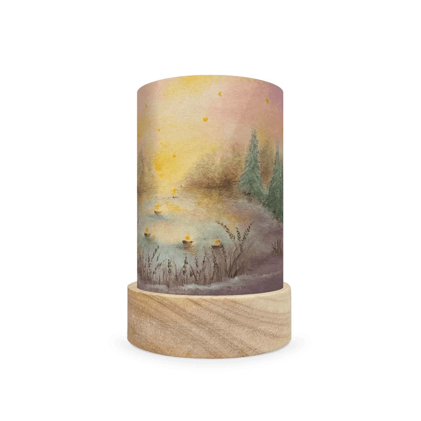 Decorative lamp with a wooden base and painted scene  of christmas trees on the edge of a lake on a white background