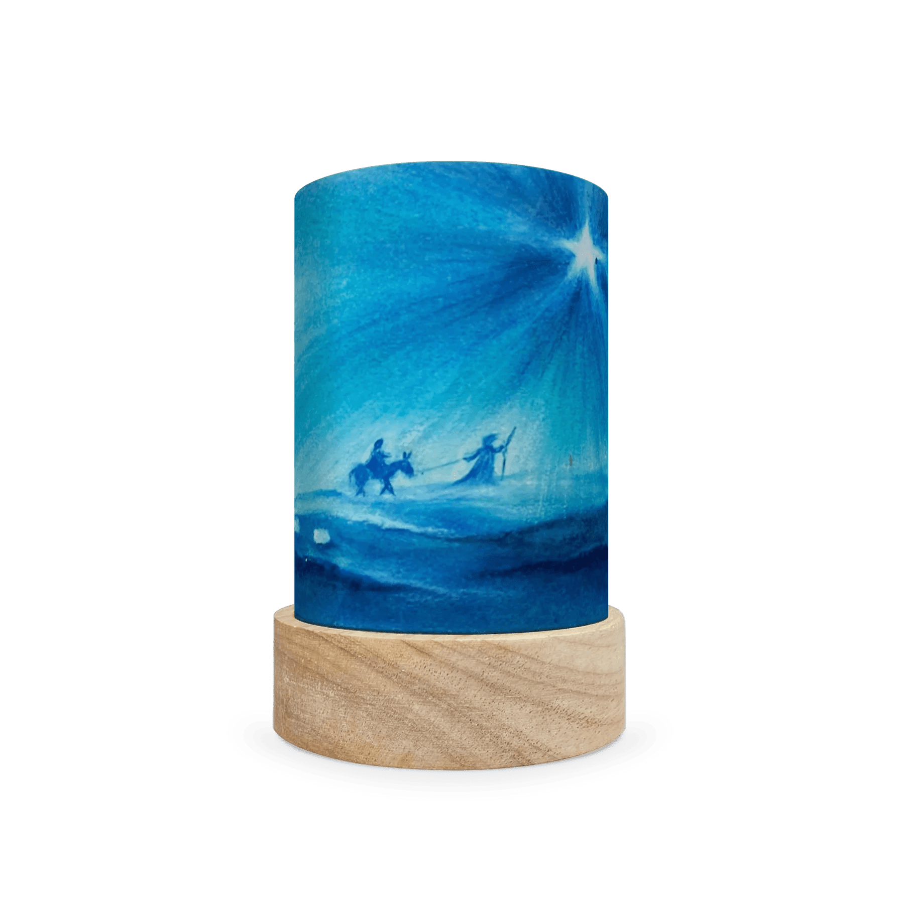Decorative lamp with scene of Mary and Joseph following a star on a wooden base on a white background