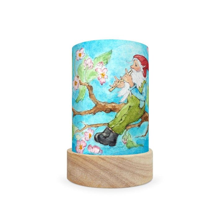 Decorative lamp with a scene of a gnome in a tree on a blue background