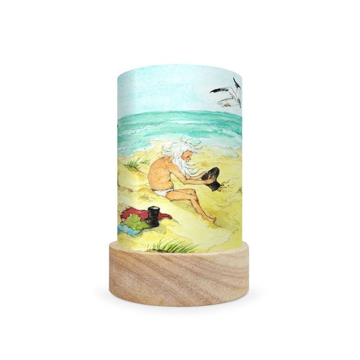 Decorative lamp with a scene depicting a gnome on the beach on a white background