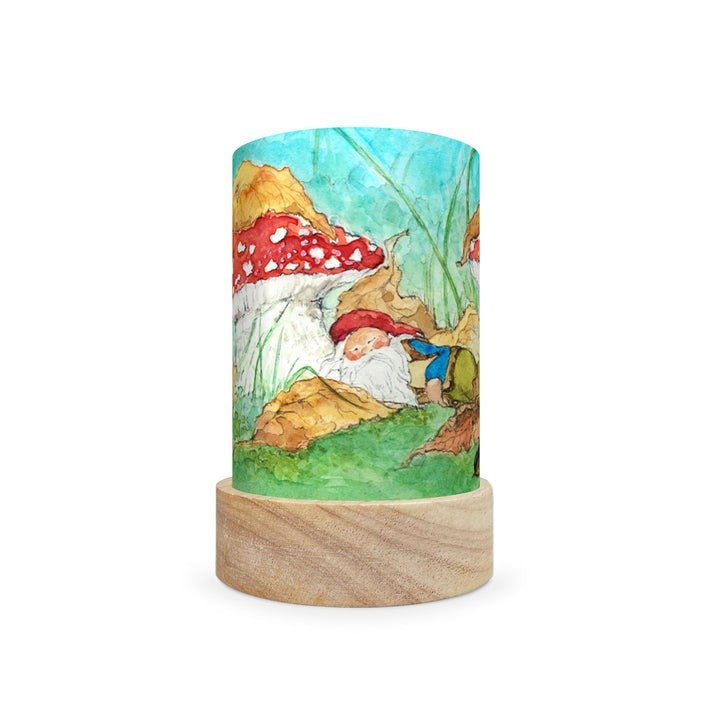 Decorative lamp depicting a scene of a gnome sleeping under a mushroom on a white background