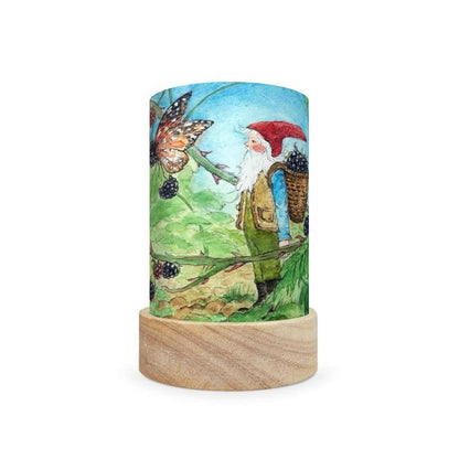 Decorative lamp with a scene depicting a gnome gathering blackberries on a white background
