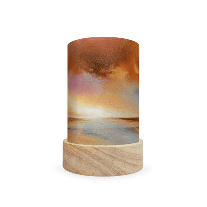 Cylindrical lamp with a wooden base and sunset landscape on a white background