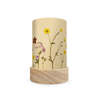 Mini lantern silhouette of pressed yellow, pink, and red flowers on a light background