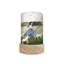 Cylindrical lantern depicting scene of a girl shepherding sheep on a white background