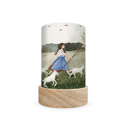 Cylindrical lantern depicting scene of a girl shepherding sheep on a white background