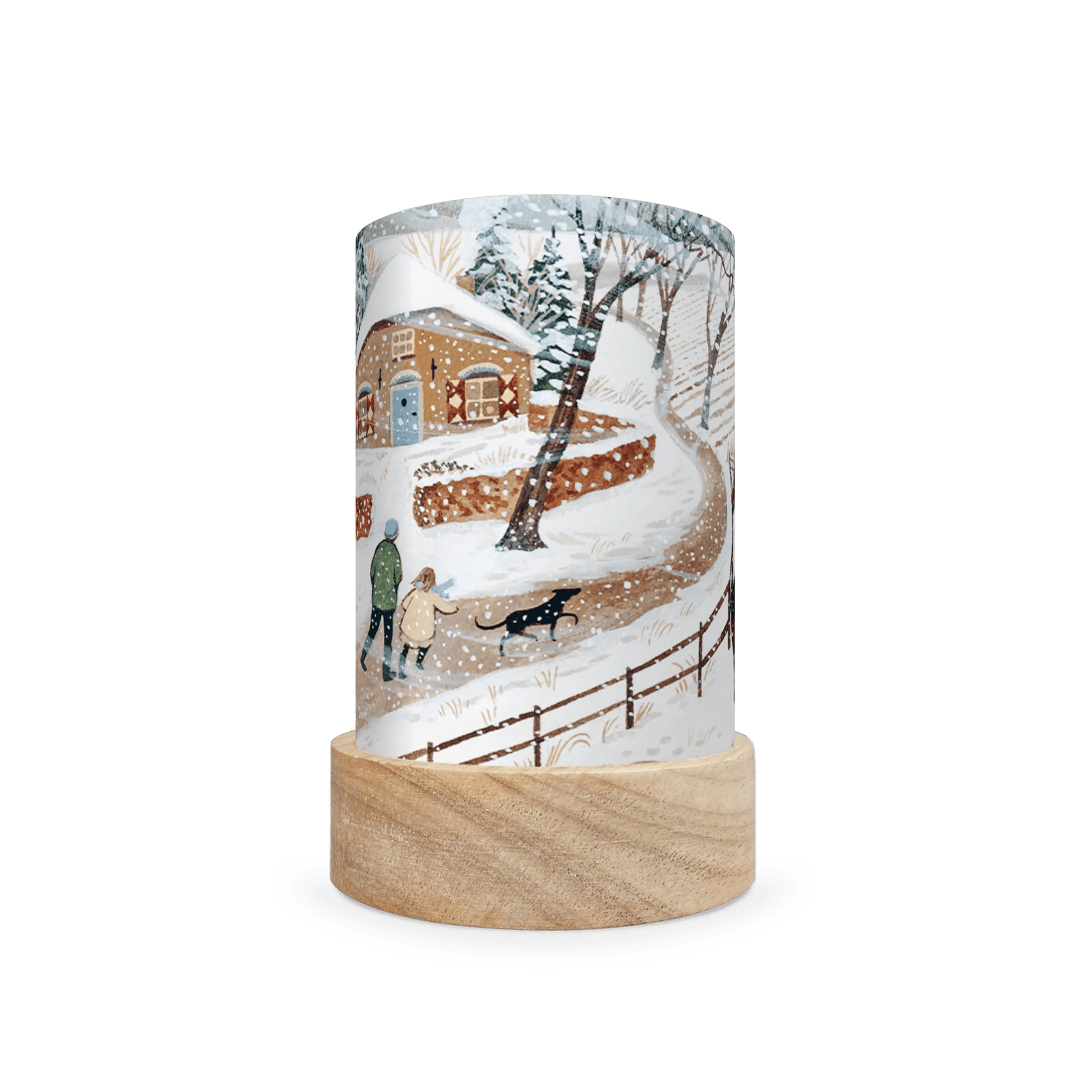 Decorative lamp depicting a scene of two people walking a dog in the snow on a white background