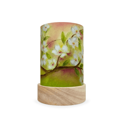 Decorative cylindrical lamp featuring white spring flowers