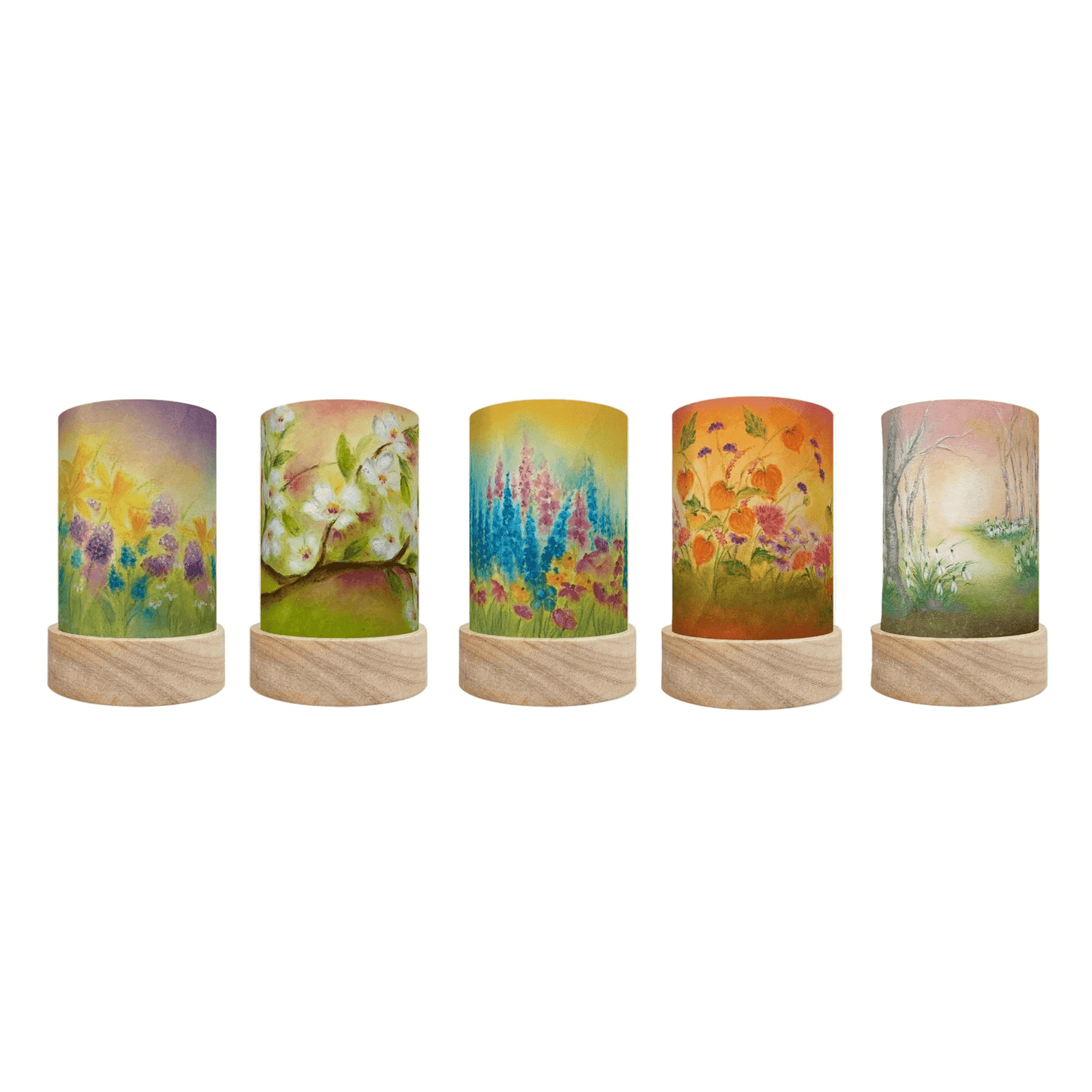 Decorative cylindrical lamps with seasonal floral designs on a white background