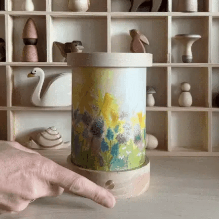 Finger demonstrating dimming switch on lantern