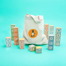 Canvas bag with a logo of a goosewearing a tophat and tie, surrounded by colorful alphabet blocks
