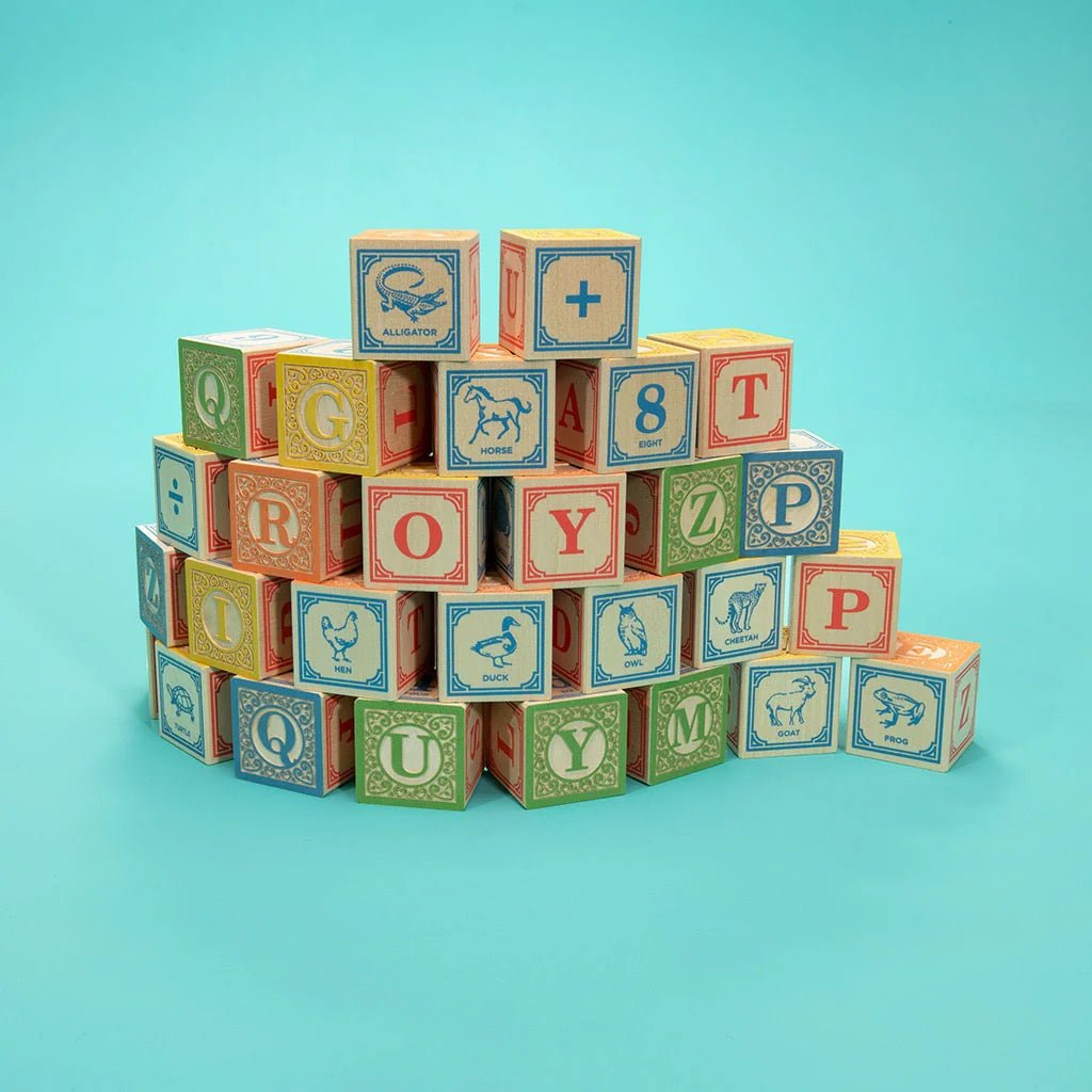 Four rows of colorful alphabet blocks stacked on top of each other on a teal background