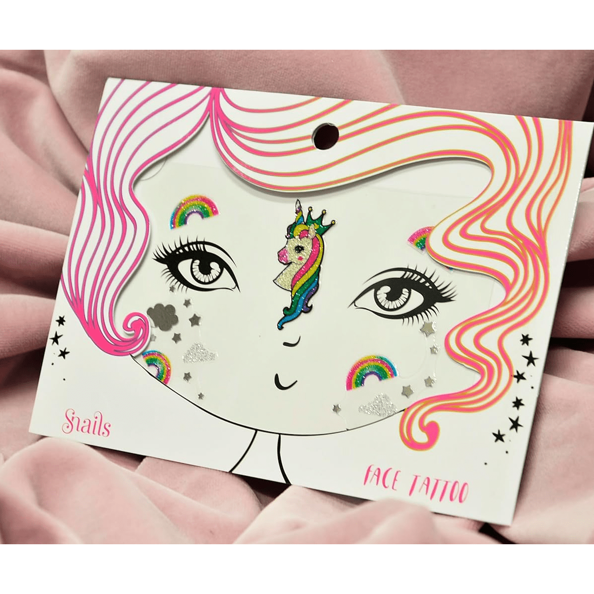 Unicorn face tattoo with clouds and rainbows on a pink background