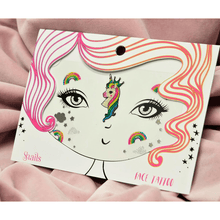 Unicorn face tattoo with clouds and rainbows on a pink background