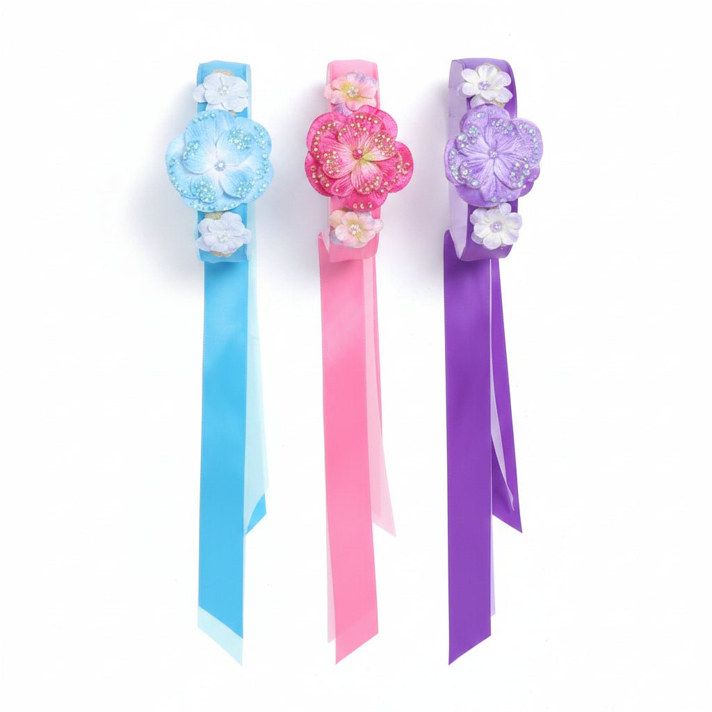 Teal, fuschia, and purple velvet pansy headbands on a white background