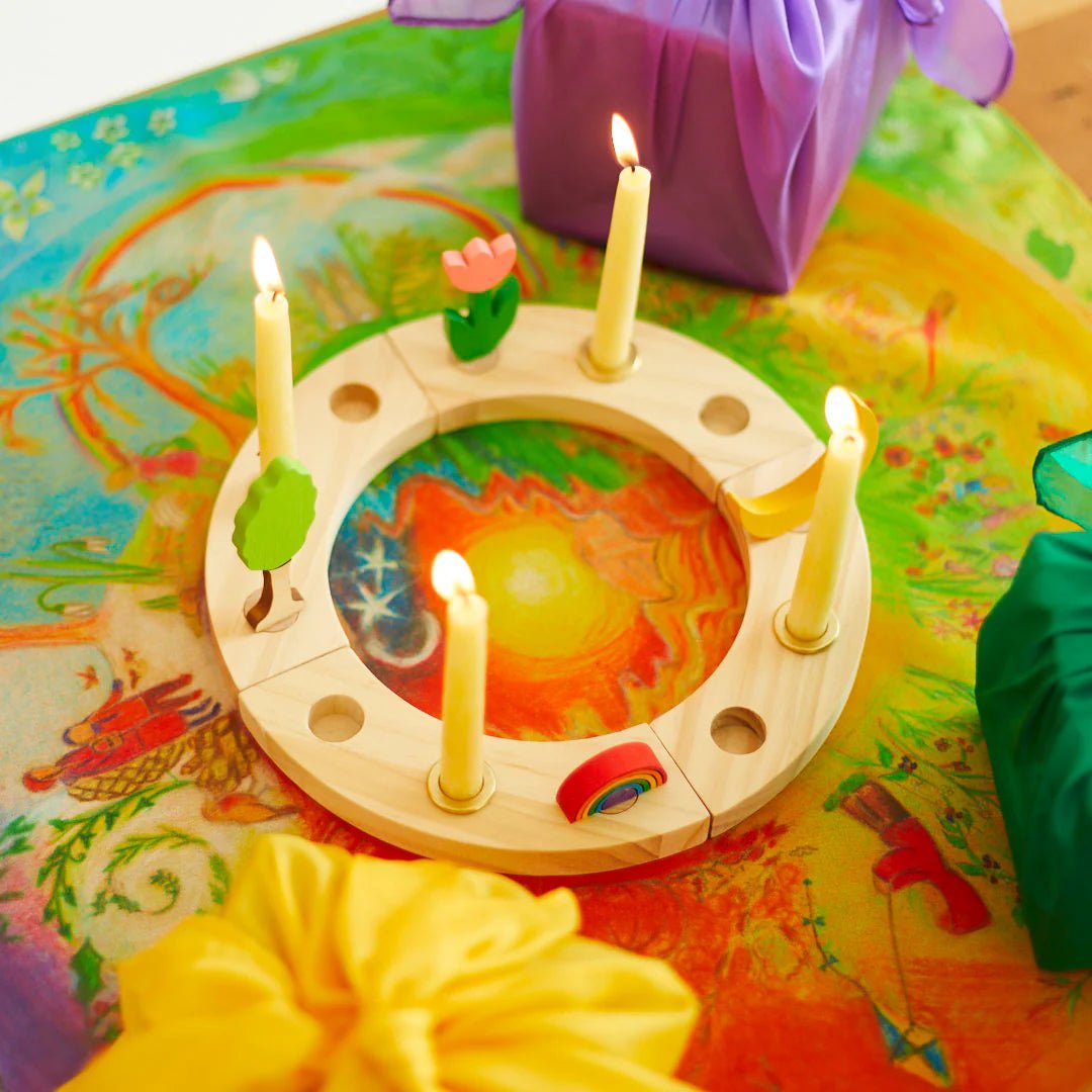 Wooden ring with charms and candles on a silk 