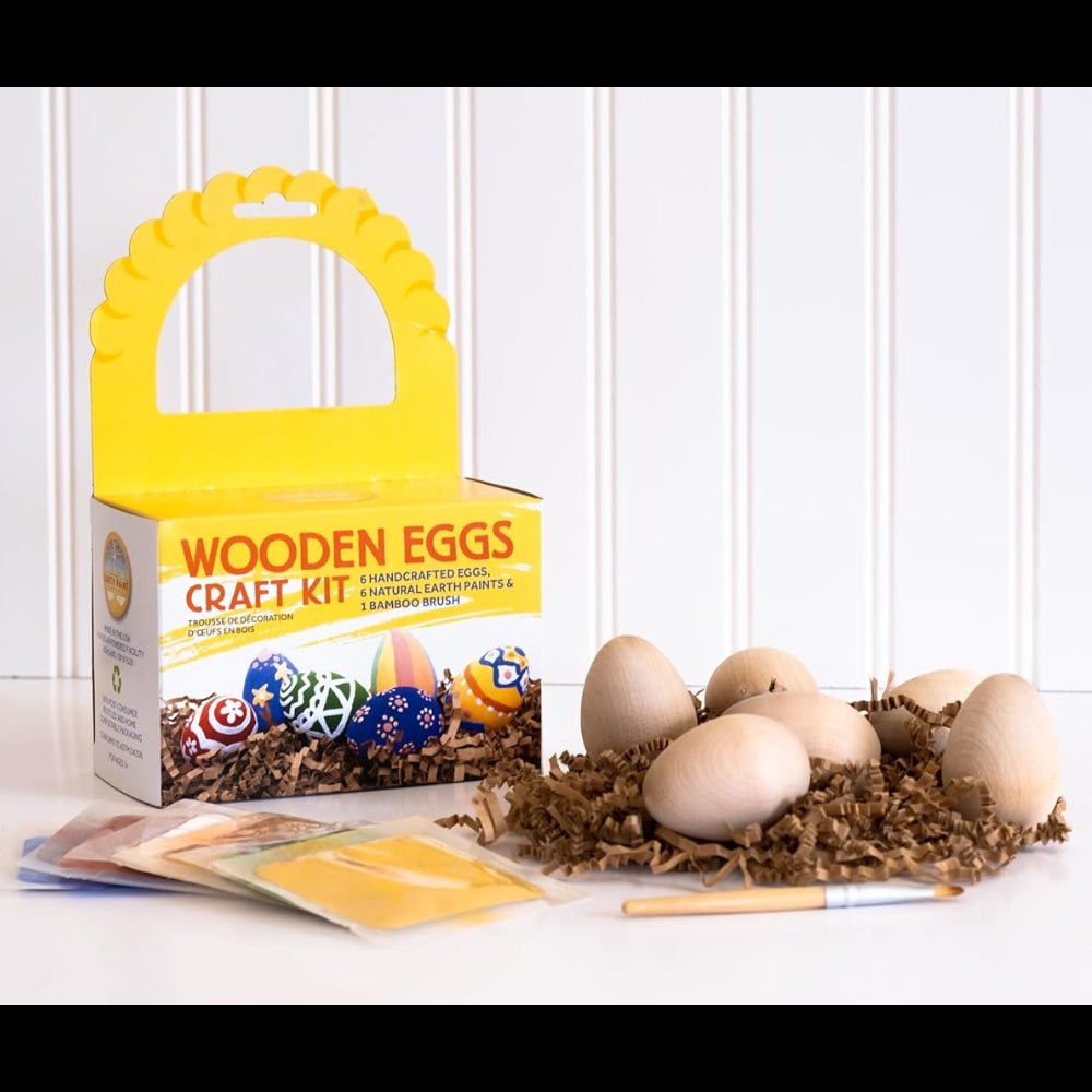 Wooden eggs craft kit with eggs and supplies on a white surface