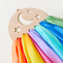 Wooden silk display with star and moon cutouts, featuring colorful silks on a white background