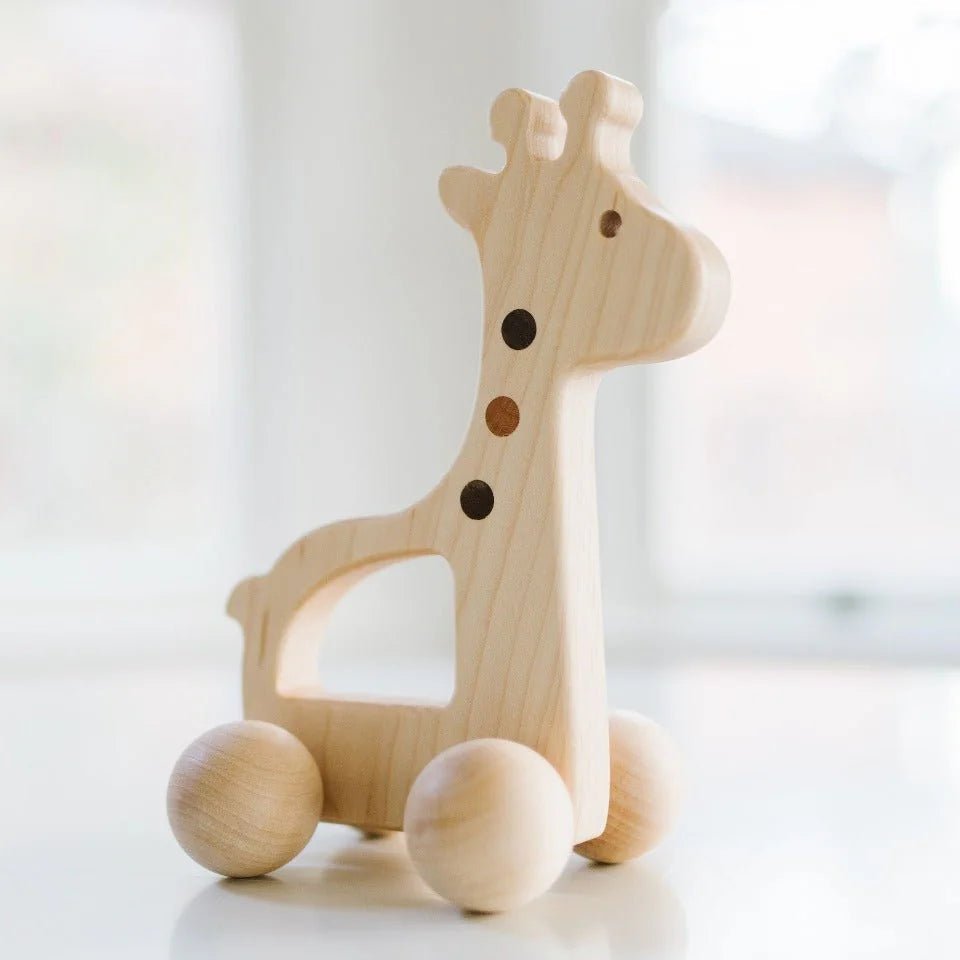 Wooden push toy giraffe on a white background