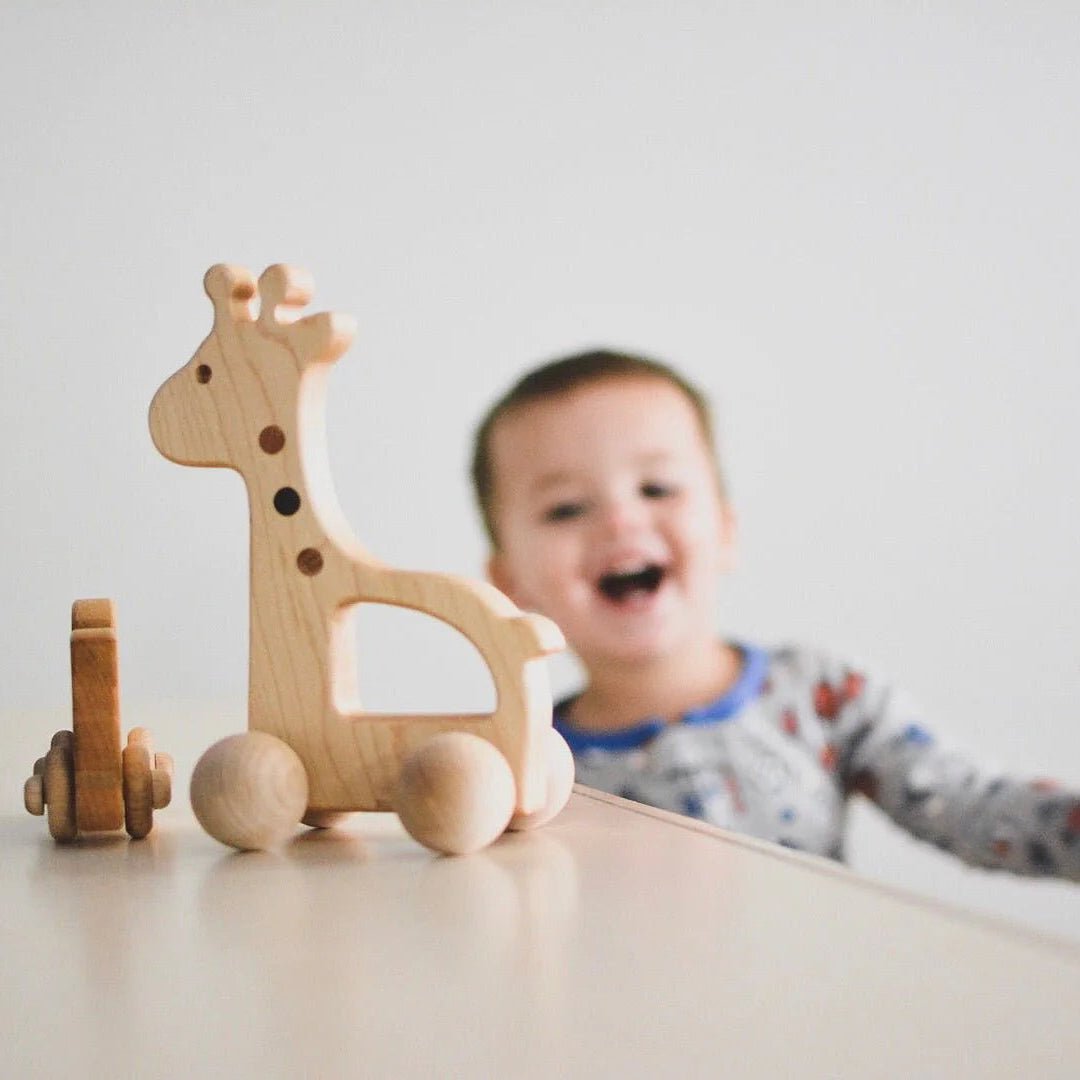Wooden giraffe toy on a table with a child in the background