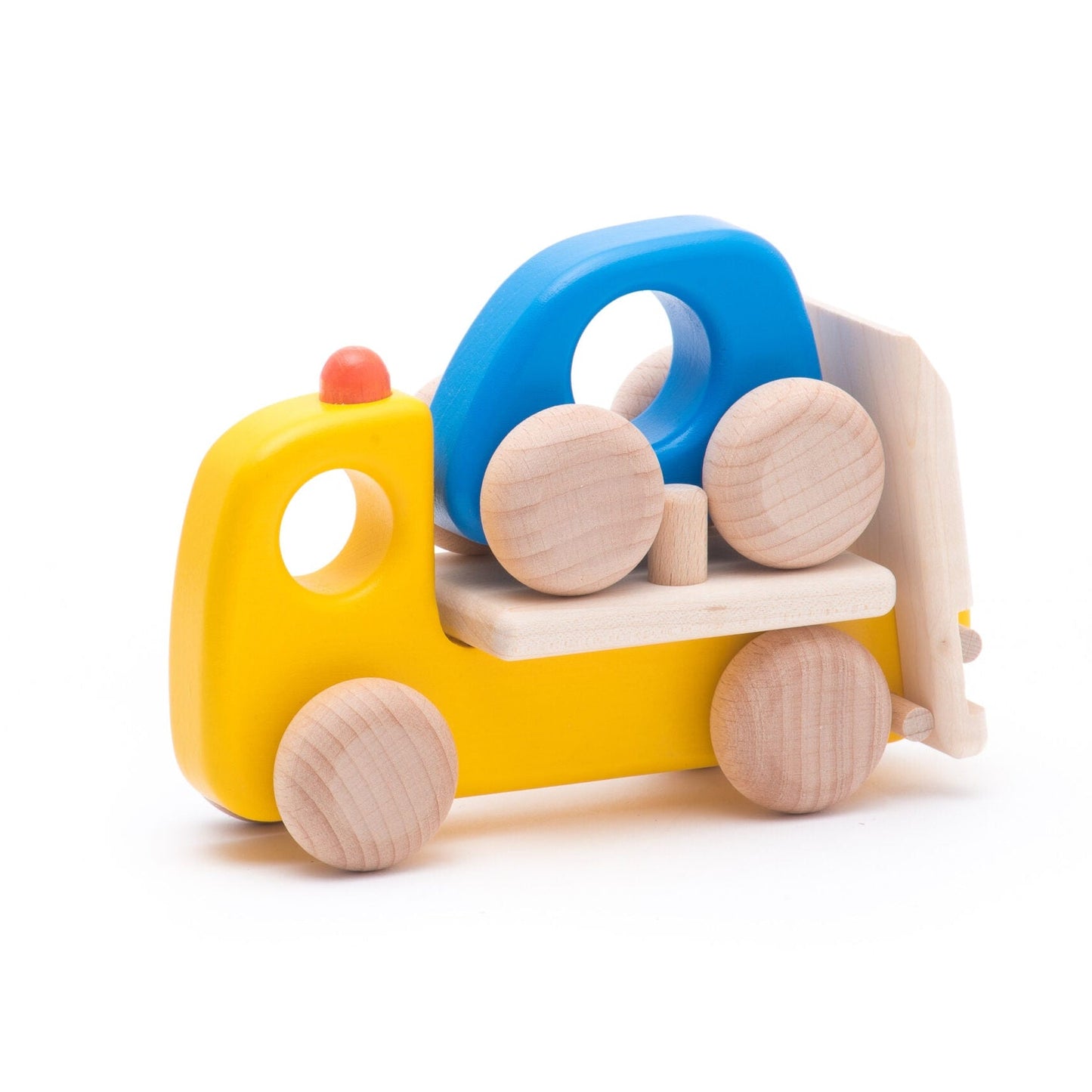 Yellow wooden toy tow truck carrying a blue car on a white background