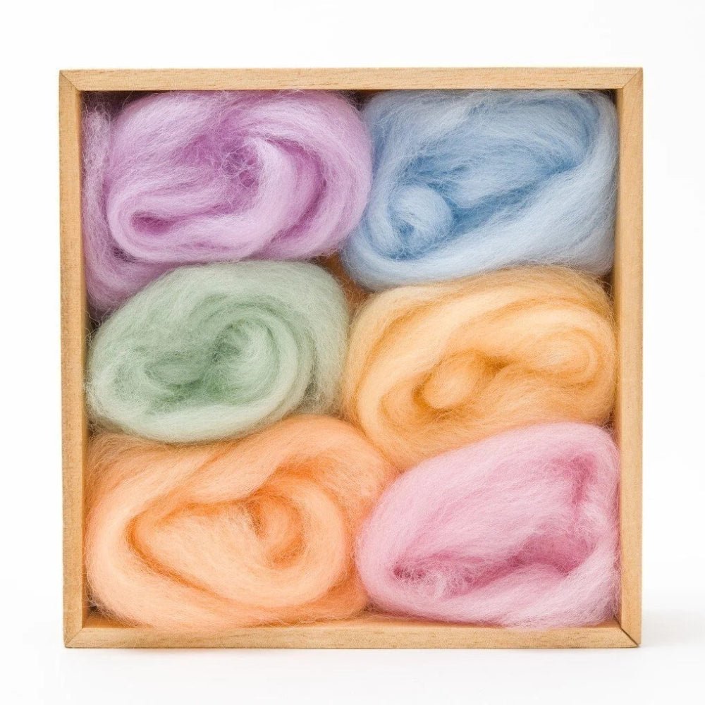6 balls of wool in pastel shades in a wooden storage box on a white background