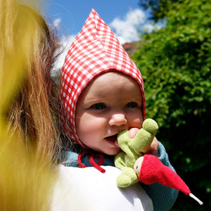 
                  
                    Nanchen Wichtel doll held by baby
                  
                