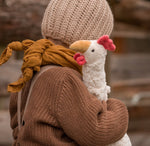 child holding senger cuddle chicken
