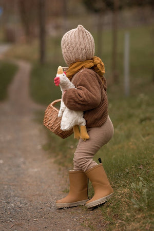 
                  
                    child holding senger cuddle chicken
                  
                